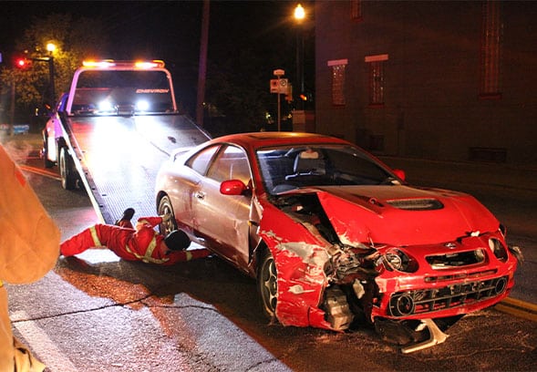 a-wrecked-car-is-loaded-onto-a-tow-truck-after-cra